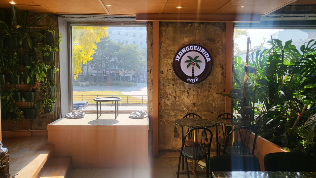 Inside Jeong Geurida Nature Cafe Near Heunginjimun Gate with plants and cozy seats